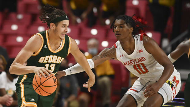 Nov 17, 2021; College Park, Maryland, USA; George Mason Patriots forward Josh Oduro (13) dribbles as Maryland Terrapins forward Julian Reese (10) defends during the second half at Xfinity Center. Mandatory Credit: Tommy Gilligan-USA TODAY Sports